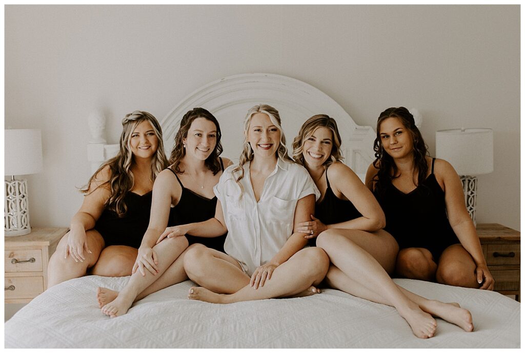 bridesmaids sitting on bed