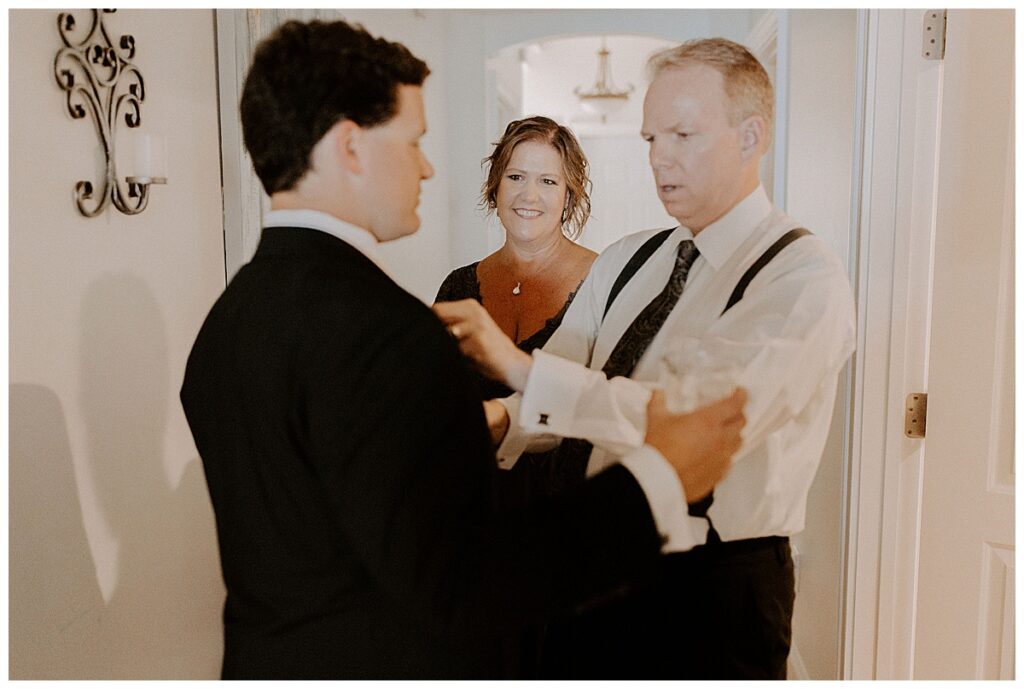 dad helping groom with tie