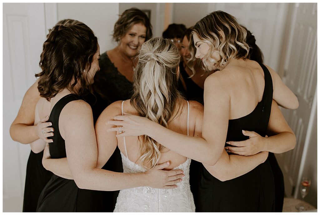 Bridesmaids surrounding bride