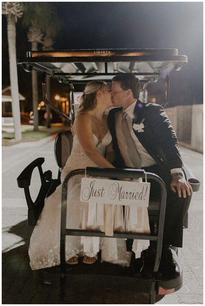 bride and groom on golf cart