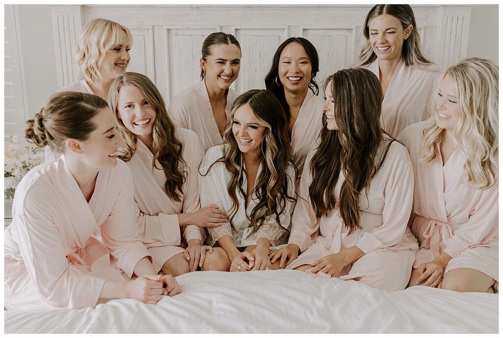 bride and bridesmaids on bed