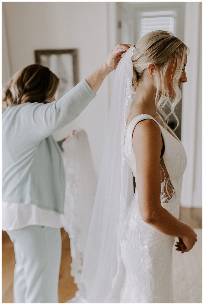 grandma helping bride with veil