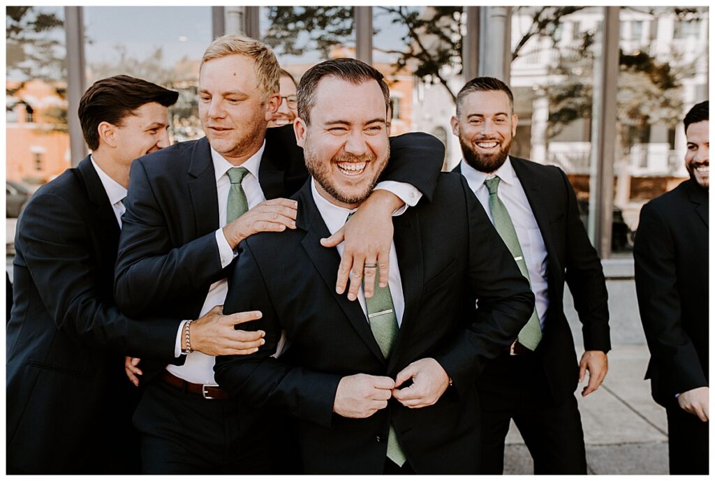 Groomsmen hugging groom