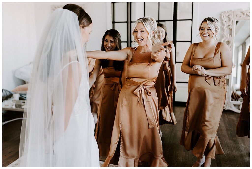 Bridemaid going to hug bride