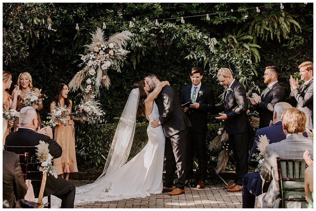 Ceremony photo of bride and groom/first kiss photo