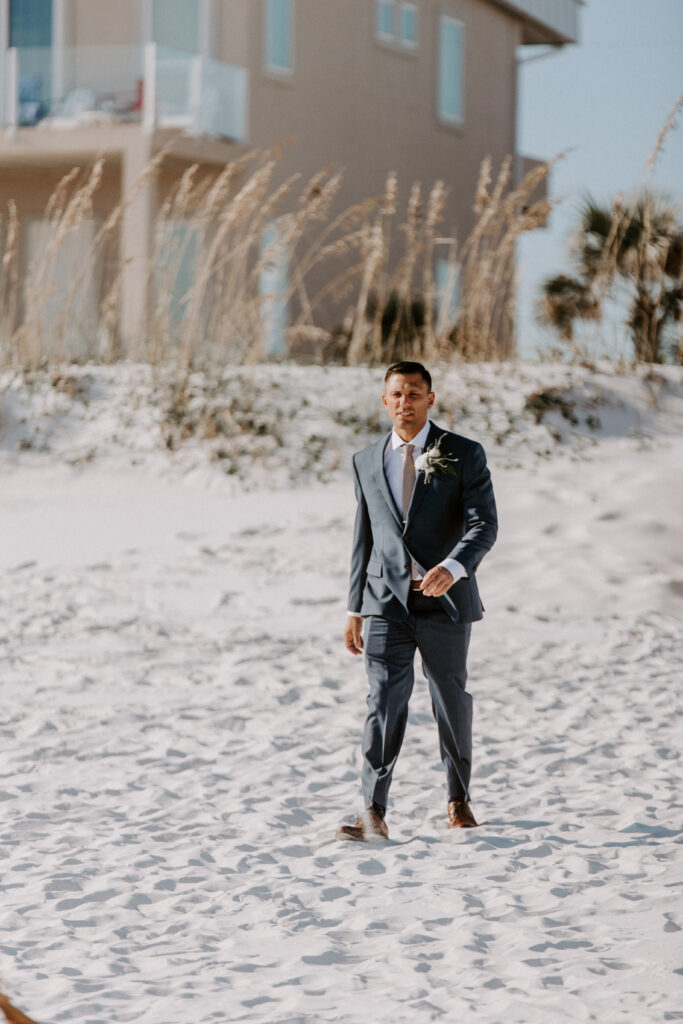 groom walks down aisle