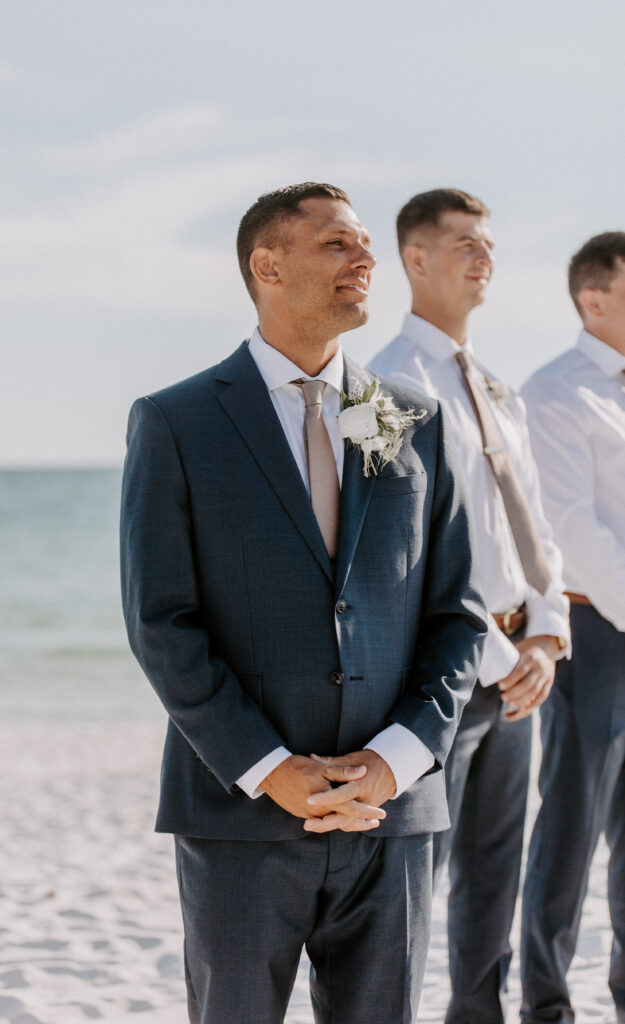 groom watches bride walk down aisle