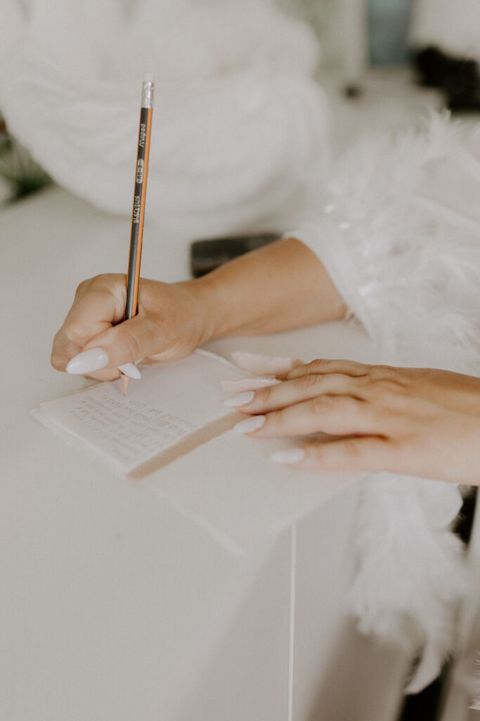 Closeup of bride writing wedding vows
