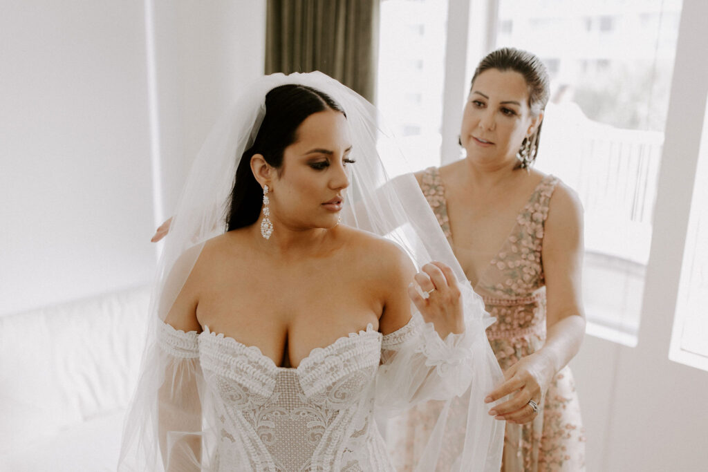 Bride's mom helping with veil