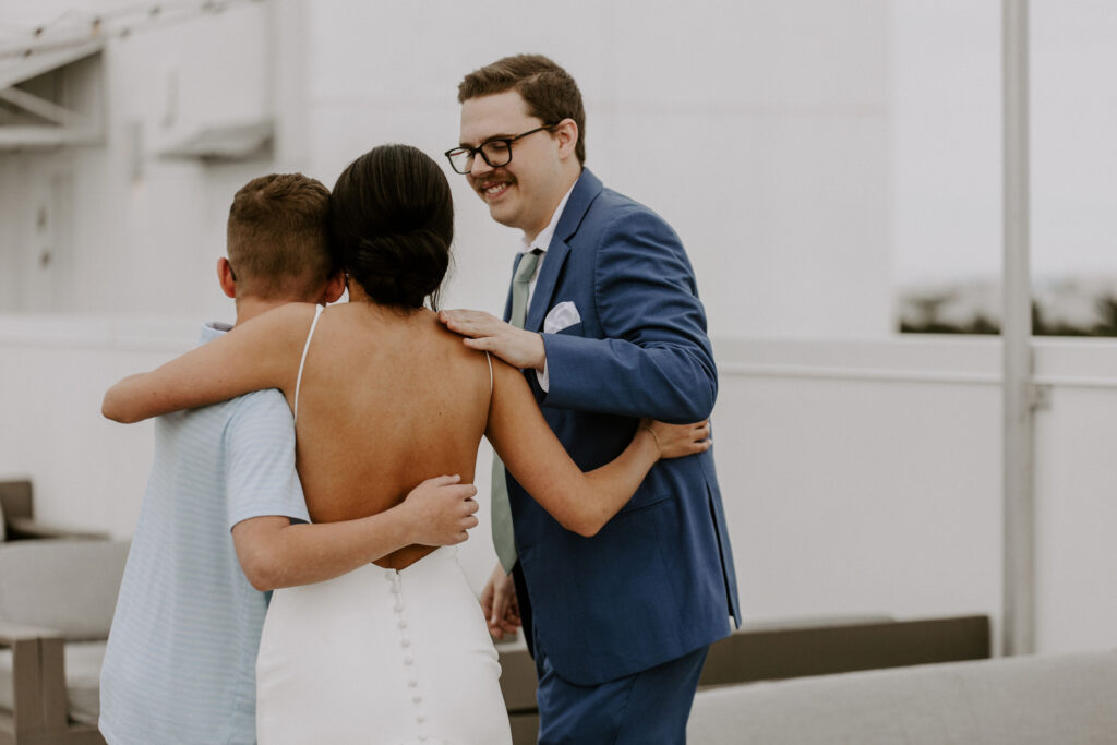 bride hugging brothers