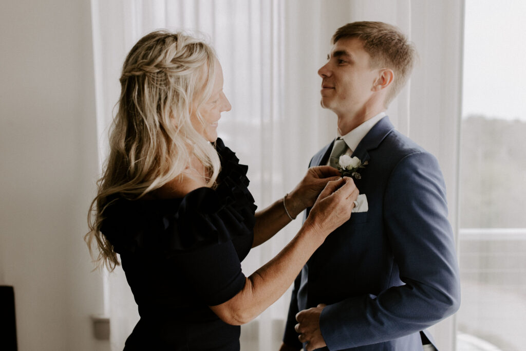 mom helping groom get ready