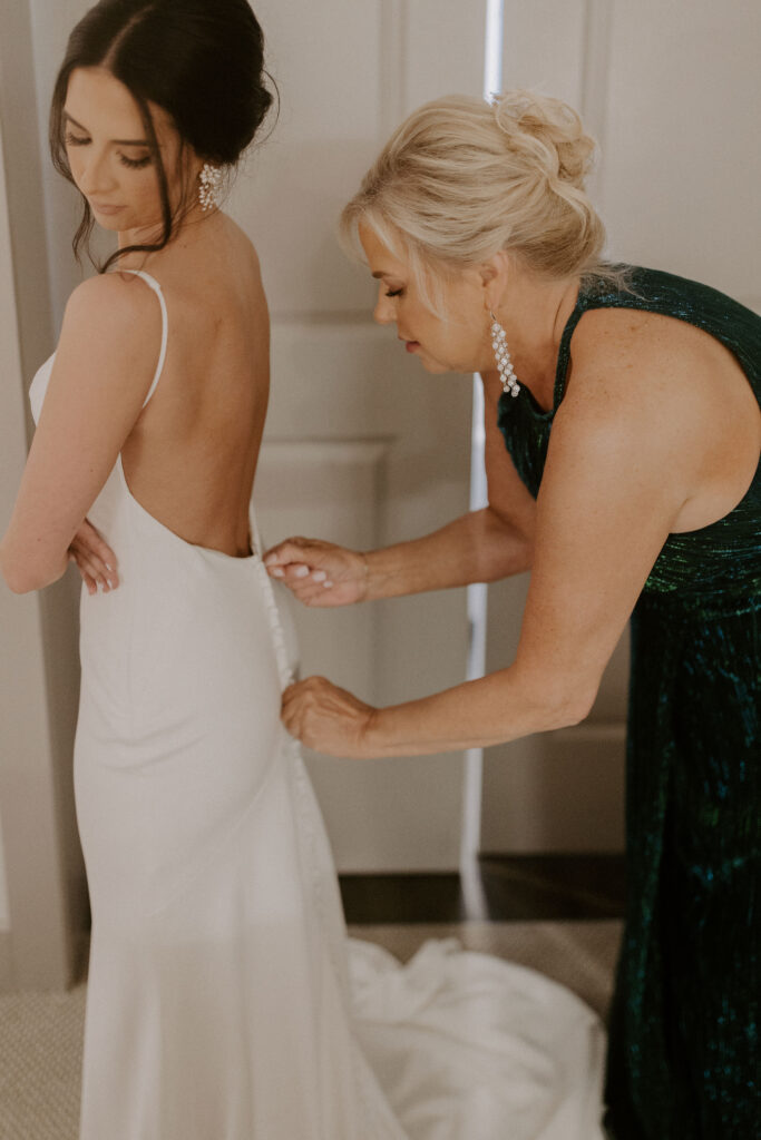 bride putting on dress