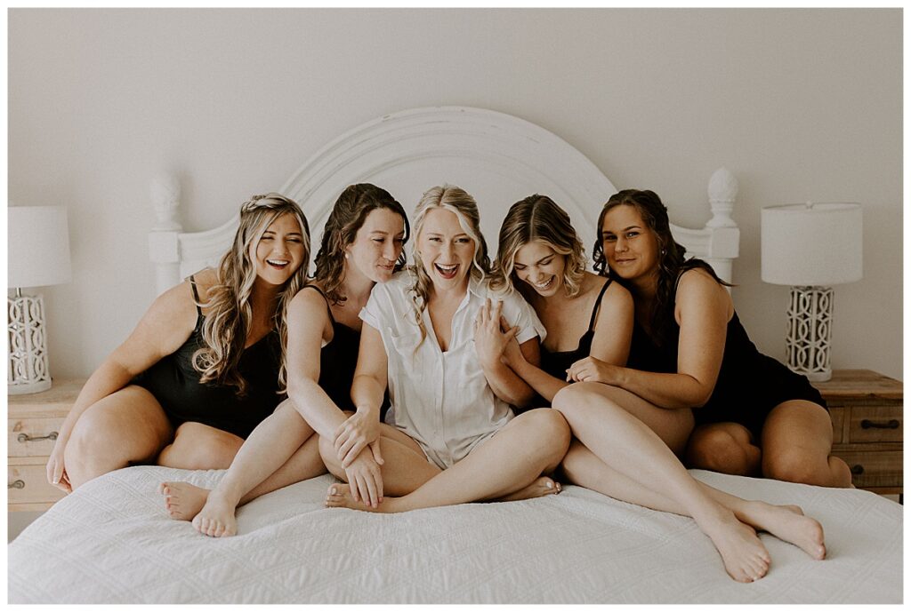 Bridesmaids sitting on bed