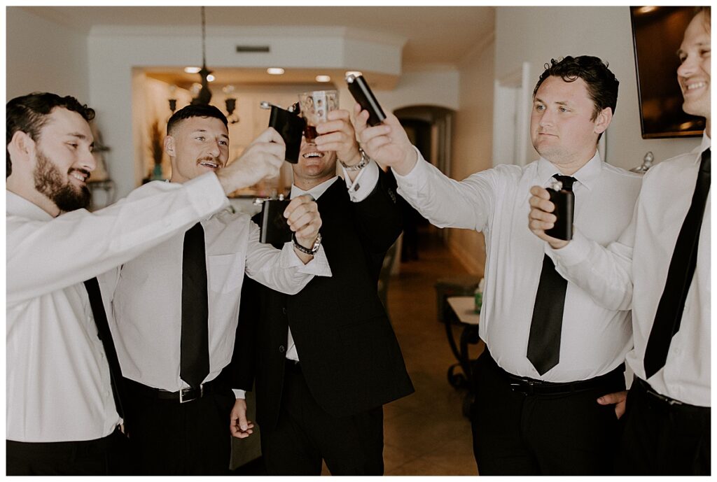 groom and groomsmen taking a shot