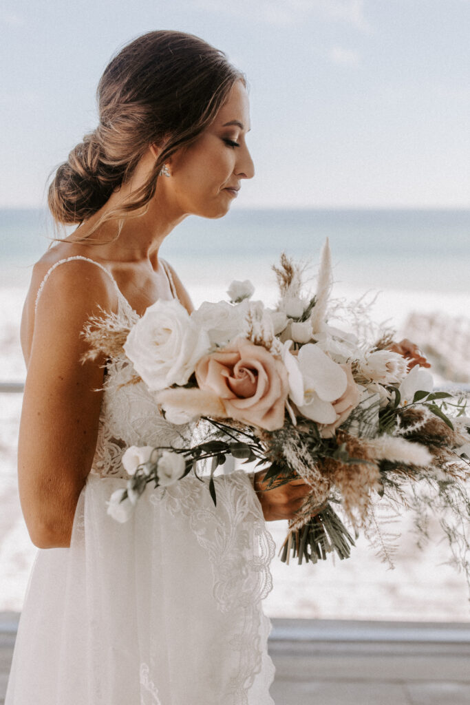 portrait of bride looking at her bouquet
