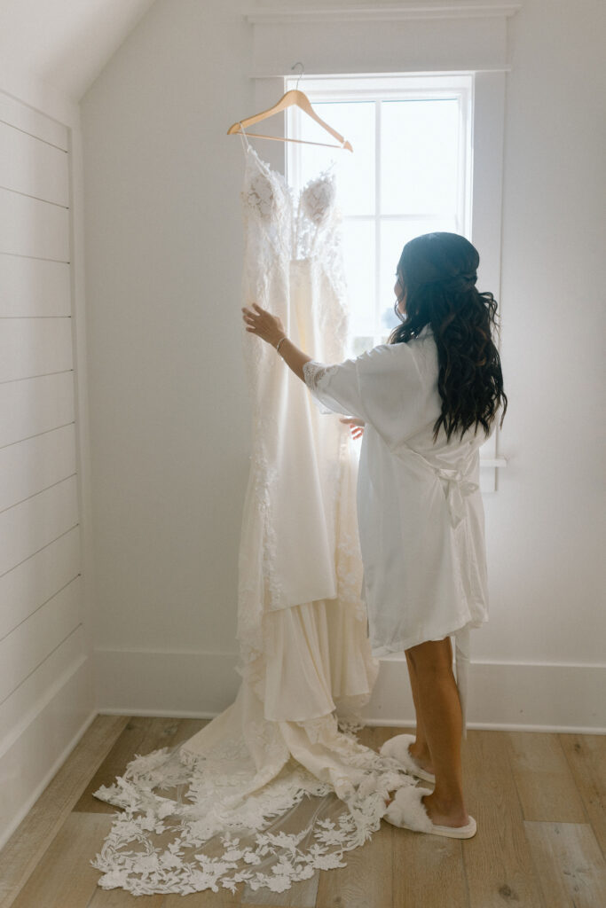 Bride looking at wedding gown