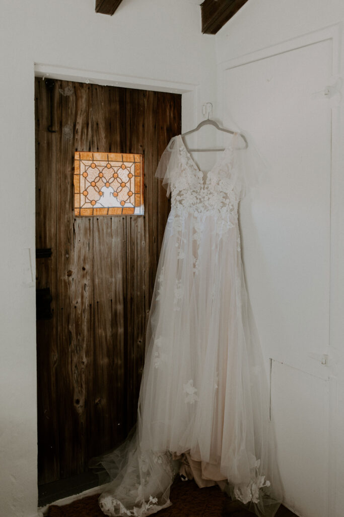 Wedding dress hanging in front of a door